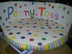 a polka dot chair with the word penny tots written on it's back