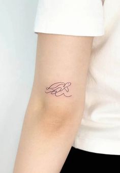 a woman with a small tattoo on her arm