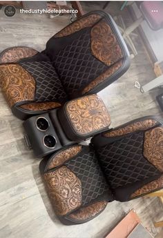 three black and brown car mats with intricate designs on them