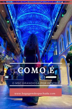 a woman walking down a hall with blue lights on the ceiling and text that reads comoe