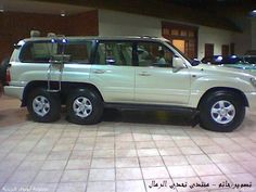 a white suv parked in front of a building