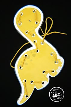 a paper cut out of a duck with yellow string around it's neck and feet