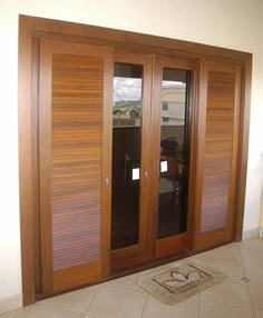 a room with wooden doors and tile flooring