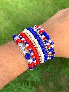 Proudly show your patriotism with the America Bracelet. This stunning set of red, white, and blue bracelets commands attention, whether worn separately or stacked together for a bold, layered look. The America Bracelet is the perfect way to accessorize your outfits and let your American pride shine. Slip it on to feel a sense of unity and strength, no matter where your day takes you. This versatile set is a must-have for any patriotic fashionista. American Pride, Layered Look, Blue Bracelet, Bracelet Stack, Memorial Day, American Flag, Arm Band, 4th Of July, Labour Day