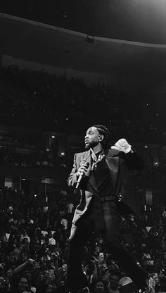 a man standing on top of a stage in front of a crowd