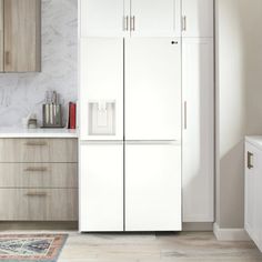 a white refrigerator freezer sitting inside of a kitchen