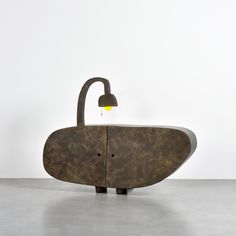 a sink with a faucet in the shape of an oval shaped object on it