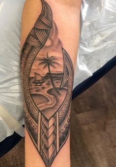 a man's arm with a tattoo on it and a palm tree in the middle