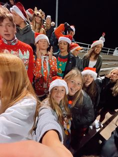 a group of young people wearing christmas hats