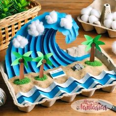 an egg carton filled with sand and palm trees on top of a wooden table