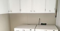 a white washer and dryer sitting next to each other in a laundry room