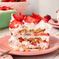 a piece of cake with strawberries on top is sitting on a plate next to the rest of the cake