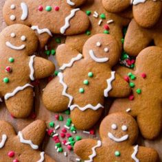 a bunch of gingerbreads with white icing and green sprinkles