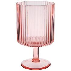 a pink glass vase sitting on top of a table