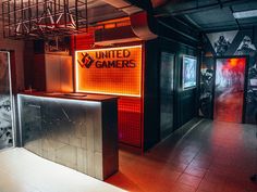 the entrance to an indoor gaming room with neon lights