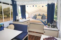 the interior of a camper with blue and white decor