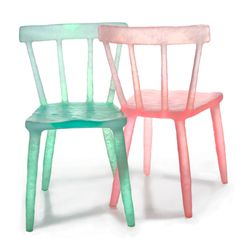 two plastic chairs sitting next to each other