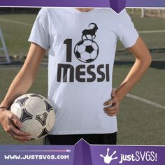 a young man holding a soccer ball in front of his shirt that says messi