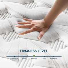 a woman's hand on top of a firmness level mattress