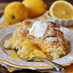 a close up of a plate of food with lemons and powdered sugar on it