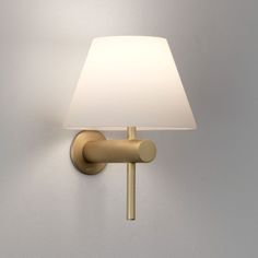 a wall light with a white shade on the top and bottom part of it's arm