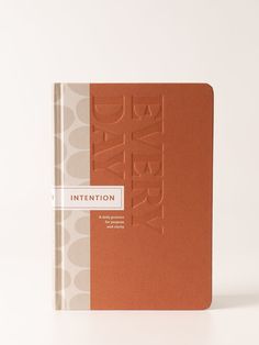 an orange and white book with the word intention written on it's front cover