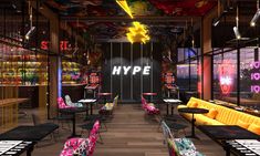 the interior of a restaurant with colorful chairs and tables in front of a large sign that says hype