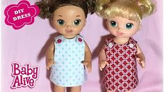 two dolls standing next to each other in front of a pink background with the words baby alive on it