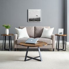 a living room with two tables and a couch