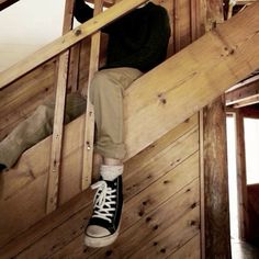 a person sitting on top of a wooden staircase