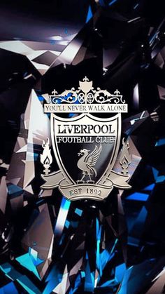 the liverpool football club crest is surrounded by blue and black crystals