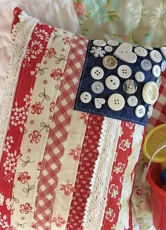 a red white and blue pillow with buttons on it