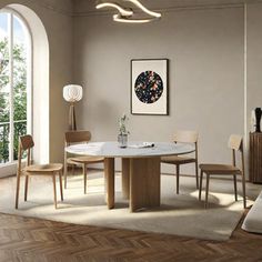 a dining room table and chairs in front of a large window with an arched doorway