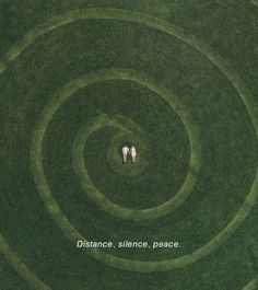 two people are standing in the middle of a circular grass field with words distance, silence, peace