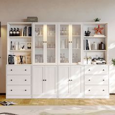 a white bookcase filled with lots of books on top of a hard wood floor