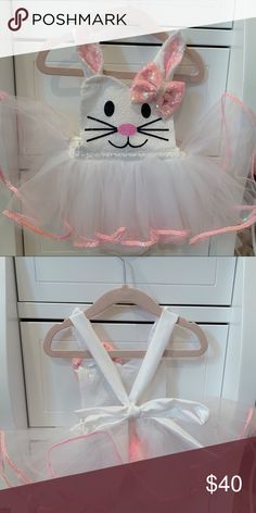 a white bunny costume with pink ears and tutuffs on it's chest