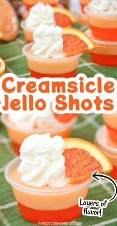 orange jello shots with whipped cream on top and an orange slice in the middle