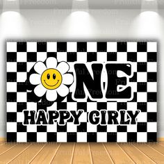 a black and white checkered wall with a smiley face on it, the words one happy