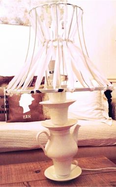 a white lamp sitting on top of a wooden table