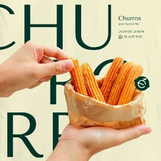 a hand holding a bag full of churros in front of a white background