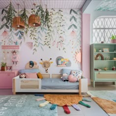 a child's bedroom decorated in pastel pink and blue with lots of plants on the wall