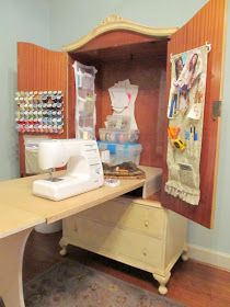 a sewing machine sitting on top of a wooden table in front of a cabinet filled with crafting supplies