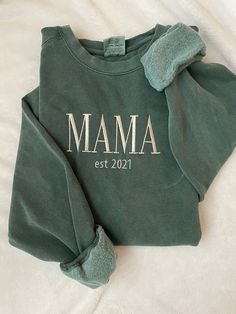 "Time to get comfy! This embroidered sweatshirt will be your new favorite with the bold \"MAMA\" in a modern font and underneath, the year you became a mama 🤍 Customize the sweatshirt with your choice of sweatshirt color from three different brands, as well as the thread color.  In the personalization field, please note the following: 1. Sweatshirt brand and color 2. Thread color 3. Year for est -Sizes available: Adult Small - Adult 2XL (3XL available for select options upon request)  -Fit: noted on pictures for each brand's colors -Machine embroidered  -design centered on chest" Winter Letter Embroidery Sweatshirt For Loungewear, Winter Loungewear Sweatshirt With Letter Embroidery, Winter Loungewear Tops With Letter Embroidery, Relaxed Fit Sweatshirt For Mother's Day Loungewear, Mother's Day Relaxed Fit Sweatshirt For Loungewear, Idee Cricut, Cute Shirt Designs, Pregnancy Outfits, Mama Sweatshirt