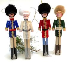 three nutcrackers standing next to each other in front of a christmas tree