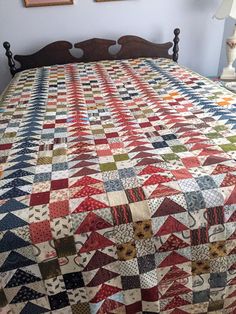 a bed with a quilt on top of it