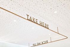 there is a sign that says take here and pick me up hanging from the ceiling