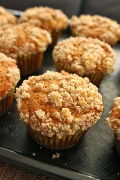 some muffins are sitting on a tray ready to be eaten