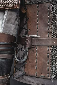 a close up of a person's armor with chains on it