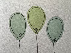 three green balloons are in the air on a white surface with black lines drawn across them