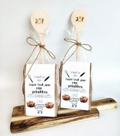 two wooden spoons with tags attached to them